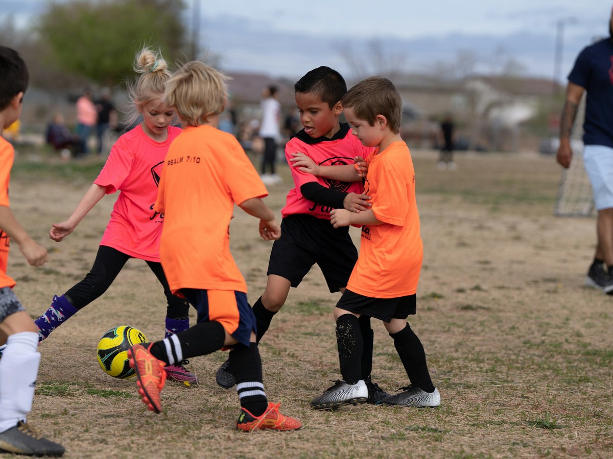 Youth players competing for the ball
